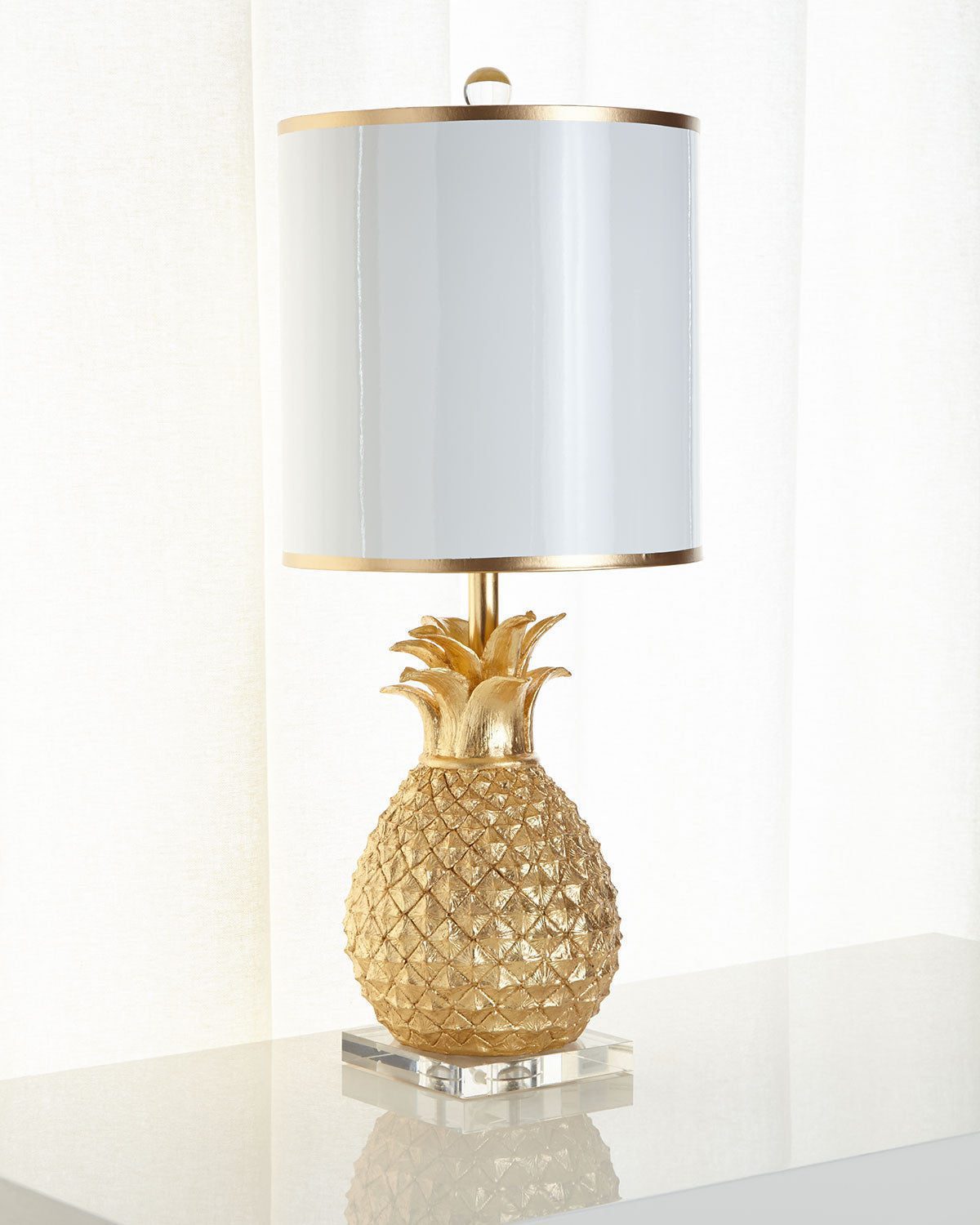 Золотая настольная лампа "Милтон" - это основание в виде золотого ананаса установлено на подставку из прозрачного акрила.